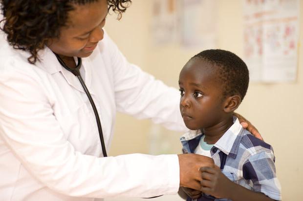Doctor examining a child patient in a clinic